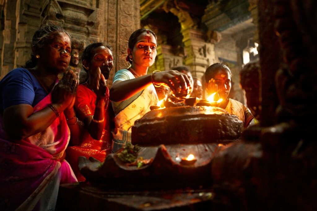 Some hindu devotees doing puja (a worship ritual) in a temple