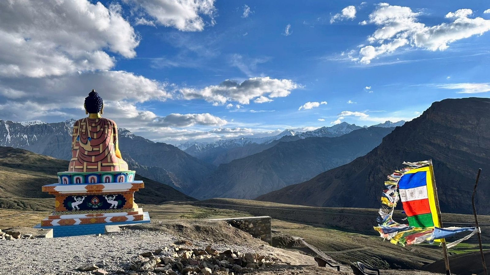 view of spiti valley mountains with buddha statue.